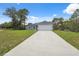 Well-maintained single-story home with a concrete driveway and lush green lawn at 16904 Sw 30Th Avenue Rd, Ocala, FL 34473