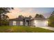 Charming single-story home with gray exterior, well-kept lawn, and two-car garage at 16904 Sw 30Th Avenue Rd, Ocala, FL 34473