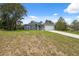 Single-story home featuring a two-car garage, gray exterior and a partial lawn at 16904 Sw 30Th Avenue Rd, Ocala, FL 34473