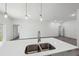 Modern kitchen island features pendant lighting and undermount sink at 16904 Sw 30Th Avenue Rd, Ocala, FL 34473