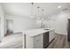 Modern open-concept kitchen featuring a large island, stainless steel appliances, and wood-look flooring at 16904 Sw 30Th Avenue Rd, Ocala, FL 34473