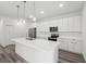 Bright, spacious kitchen featuring stainless steel appliances, a large island, and white cabinetry at 16904 Sw 30Th Avenue Rd, Ocala, FL 34473