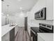 Bright kitchen features stainless appliances, modern cabinetry, and a large center island with pendant lighting at 16904 Sw 30Th Avenue Rd, Ocala, FL 34473