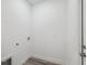 Bright laundry room with modern gray plank flooring and utility connections at 16904 Sw 30Th Avenue Rd, Ocala, FL 34473
