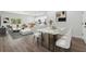 Open-concept living and dining area featuring modern decor, light hardwood floors, and contemporary lighting fixtures at 16904 Sw 30Th Avenue Rd, Ocala, FL 34473