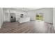 Open concept living room and kitchen features stainless appliances, white cabinets, and backyard access at 16904 Sw 30Th Avenue Rd, Ocala, FL 34473