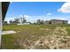 Spacious backyard with grass, showcasing the home's exterior with patio at 17139 Sw 44Th Cir, Ocala, FL 34473