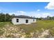 View of the backyard featuring the home's exterior and surrounding landscape at 17139 Sw 44Th Cir, Ocala, FL 34473