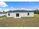 View of the backyard showcasing the home's exterior and patio at 17139 Sw 44Th Cir, Ocala, FL 34473