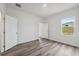 A bedroom featuring hard surface floors, baseboard trim and a window for natural light at 17139 Sw 44Th Cir, Ocala, FL 34473
