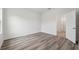 A bedroom featuring hard surface floors, baseboard trim and a window for natural light at 17139 Sw 44Th Cir, Ocala, FL 34473