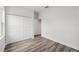 A bedroom featuring a double closet and wood-look floors at 17139 Sw 44Th Cir, Ocala, FL 34473