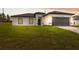Charming one-story home featuring a two-car garage, landscaped yard, and modern architectural details at 17139 Sw 44Th Cir, Ocala, FL 34473