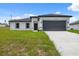 Single Gathering house features a two-car garage and modern architectural details with a blue sky background at 17139 Sw 44Th Cir, Ocala, FL 34473