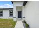 Welcoming front entrance with a well-defined path and landscaping, complemented by neutral exterior colors at 17139 Sw 44Th Cir, Ocala, FL 34473