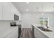 Modern kitchen featuring stainless steel appliances and sleek white cabinets and countertops at 17139 Sw 44Th Cir, Ocala, FL 34473