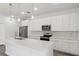 Well-appointed kitchen with stainless steel appliances, white cabinetry, and a quartz countertop island at 17139 Sw 44Th Cir, Ocala, FL 34473