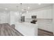 Well-lit kitchen offers white cabinets, stainless steel appliances, and a spacious island with a sink at 17139 Sw 44Th Cir, Ocala, FL 34473