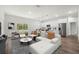 Bright living room featuring modern furniture, hardwood floors, and sliding glass doors to the backyard at 17139 Sw 44Th Cir, Ocala, FL 34473
