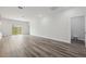 Open-concept living area features modern flooring, bright white walls, and a sliding glass door to the outdoors at 17139 Sw 44Th Cir, Ocala, FL 34473