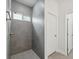 Modern tiled shower with a built-in shower head and window at 17139 Sw 44Th Cir, Ocala, FL 34473
