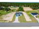Aerial view of a single-story home with a blue garage door, set in a partially landscaped yard at 17434 Sw 36Th Avenue Rd, Ocala, FL 34473
