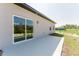 A modern concrete patio with a sliding glass door leading into the home at 17434 Sw 36Th Avenue Rd, Ocala, FL 34473