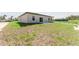 A spacious backyard with green grass and a simple concrete patio at 17434 Sw 36Th Avenue Rd, Ocala, FL 34473