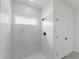 Clean-lined shower features white marble tiling, a window, and matte black shower hardware at 17434 Sw 36Th Avenue Rd, Ocala, FL 34473