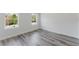 Bedroom featuring gray wood-look flooring and two windows providing ample natural light at 17434 Sw 36Th Avenue Rd, Ocala, FL 34473