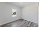 Bedroom with gray flooring and a window showing a vibrant, lush landscape at 17434 Sw 36Th Avenue Rd, Ocala, FL 34473
