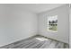 Bedroom with a window showcasing the outdoors and wood-look flooring at 17434 Sw 36Th Avenue Rd, Ocala, FL 34473