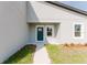 Close-up of front entrance with a dark teal door, trimmed window, and fresh landscaping at 17434 Sw 36Th Avenue Rd, Ocala, FL 34473