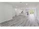 Bright open-concept living area with gray wood-look flooring and recessed lighting at 17434 Sw 36Th Avenue Rd, Ocala, FL 34473