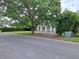 Attractive home with mature shade tree, manicured hedges, and brick driveway creating a welcoming curb appeal at 1773 Walnut Ave, Winter Park, FL 32789