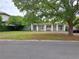 Single-story home with dual entrances, brick driveway, and mature trees, blending comfort and curb appeal at 1773 Walnut Ave, Winter Park, FL 32789