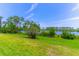 Expansive backyard featuring lush green grass and a scenic view of the lake at 17840 Passionflower Cir, Clermont, FL 34714