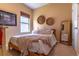 Cozy bedroom featuring a comfortable bed, a window for natural light, and decorative wall decor at 17840 Passionflower Cir, Clermont, FL 34714