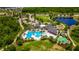 Aerial view of the community clubhouse and pool area amid lush landscaping and serene ponds at 17840 Passionflower Cir, Clermont, FL 34714