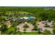 Aerial view of the community clubhouse, pool, playground, and meticulously landscaped grounds at 17840 Passionflower Cir, Clermont, FL 34714