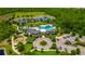 Aerial view of the community clubhouse, pool, playground, parking lot and beautiful landscaping at 17840 Passionflower Cir, Clermont, FL 34714