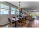 Dining area featuring modern lighting, hardwood floors, lots of windows, and sliding door access at 17840 Passionflower Cir, Clermont, FL 34714