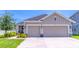 Charming home featuring a three-car garage, well-maintained lawn and landscaped front yard at 17840 Passionflower Cir, Clermont, FL 34714