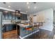 Modern kitchen features stainless steel appliances, dark cabinets, light countertops, and barstool seating at 17840 Passionflower Cir, Clermont, FL 34714