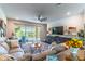 Cozy living room showcasing comfortable seating, stylish decor, and access to the outdoor screened-in patio at 17840 Passionflower Cir, Clermont, FL 34714