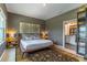 Comfortable main bedroom with decorative lamps, decorative wall hangings, and an ensuite bathroom at 17840 Passionflower Cir, Clermont, FL 34714