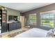 Relaxing main bedroom featuring natural light, a dresser, and a view of the outdoor pool at 17840 Passionflower Cir, Clermont, FL 34714
