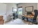Functional office space featuring a desk, computer, and natural light from the window at 17840 Passionflower Cir, Clermont, FL 34714