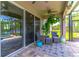 Relaxing screened-in patio features comfortable seating, ceiling fan, and serene lake views at 17840 Passionflower Cir, Clermont, FL 34714