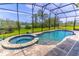 Relaxing screened-in outdoor pool and jacuzzi area with views of a serene lake and green space at 17840 Passionflower Cir, Clermont, FL 34714